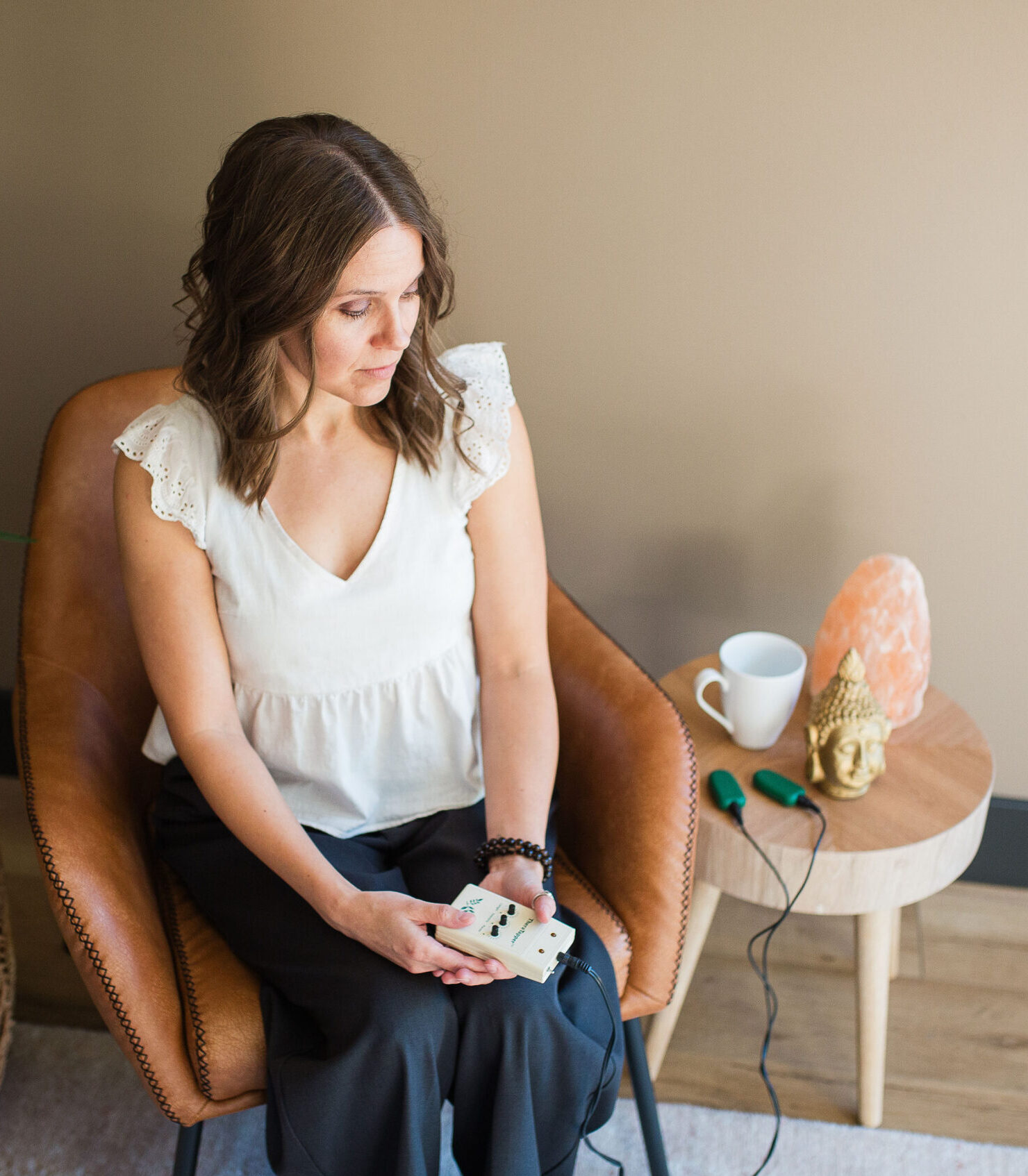 Woman sitting quietly with a journal and coffee, embodying presence in relationships and attachment-based therapy