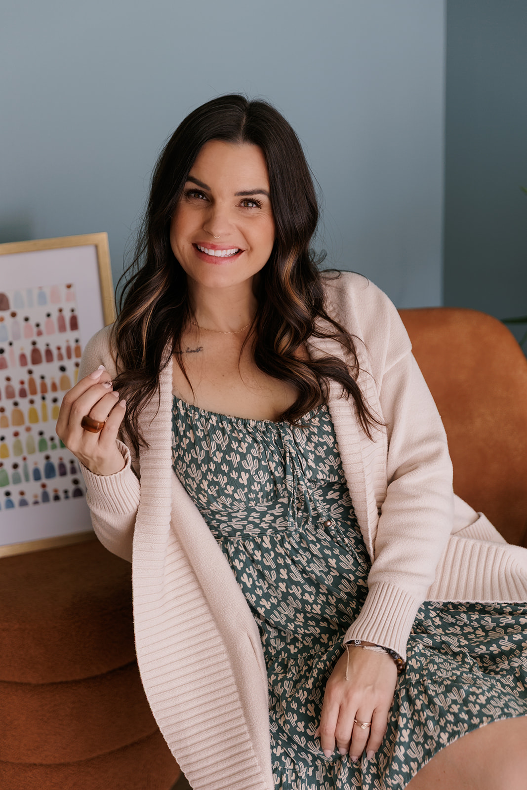 Mellissa Hill sits with LGBTQIA+ art